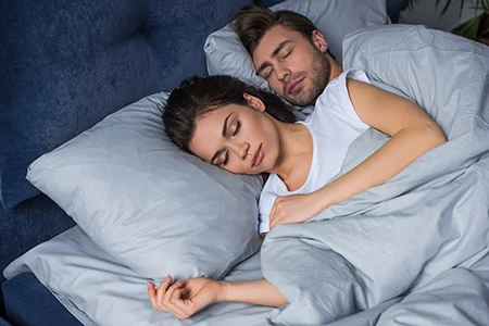 couple sleeping in bed bug free bed