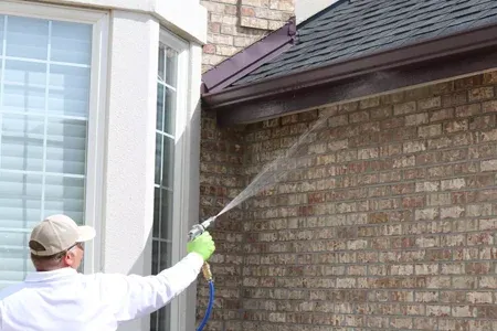 spraying exterior of home